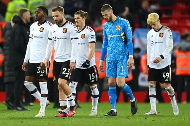 A dejected group of United players walk off after losing 7-0 to Liverpool