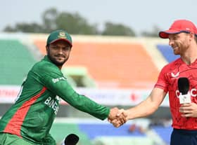 Buttler (R) shakes hands with Al Hasan ahead of T20 series