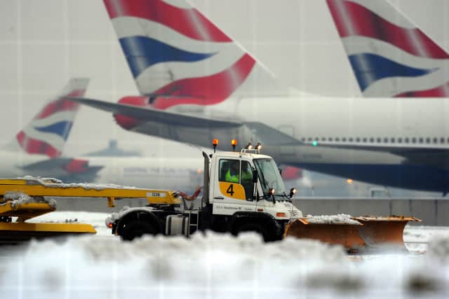 A worker operates a snow plough near the second runway, in an attempt to get it operational again, at Heathrow Airport, west of London, in December 2010 (Photo: ADRIAN DENNIS/AFP via Getty Images)