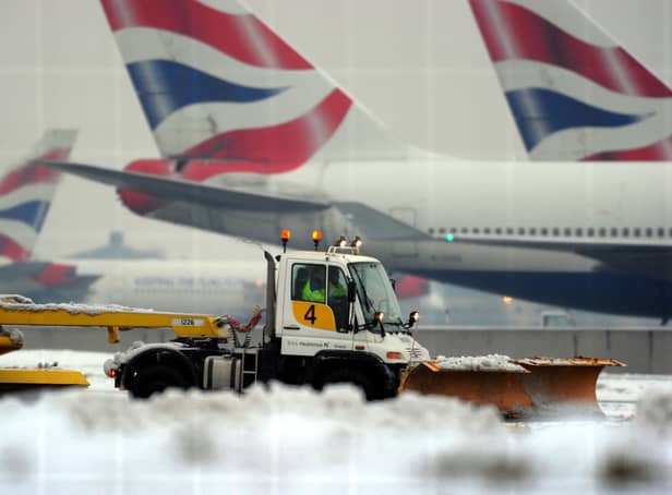 A worker operates a snow plough near the second runway, in an attempt to get it operational again, at Heathrow Airport, west of London, in December 2010 (Photo: ADRIAN DENNIS/AFP via Getty Images)