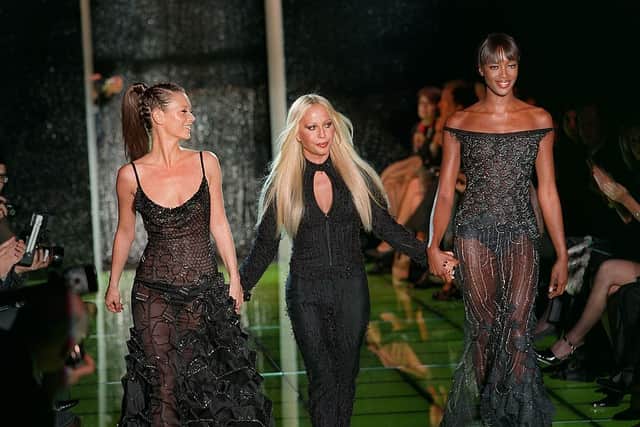 Naomi Campbell with Kate Moss and Donatella Versace at the the end of the designer's 1999 Spring/Summer haute couture show. Photograph by Getty