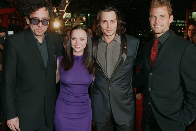 Director Tim Burton (L) poses at the premiere of his new film “Sleepy Hollow” with cast members Christina Ricci(2nd L), Johnny Depp(2nd R), and Casper Van Dien(R) in Hollywood, CA 17 November 1999. The film is a Gothic thriller based on the Washington Irving novel. (Credit: LUCY NICHOLSON/AFP via Getty Images)