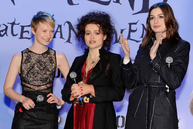 (L-R) Actors Mia Wasikowska, Helena Bonham Carter and Anne Hathaway appear onstage at Walt Disney Pictures & Buena Vista Records "Alice in Wonderland" Fan Event at Hollywood & Highland on February 19, 2010 in Los Angeles, California.  (Photo by Kevin Winter/Getty Images)