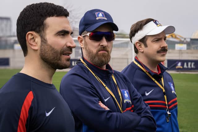 Brett Goldstein as Roy Kent, Brendan Hunt as Coach Beard, and Jason Sudeikis as Ted Lasso in Ted Lasso (Credit: Apple TV+)