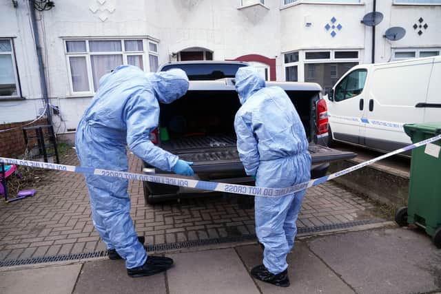 Police forensics officers examine a vehicle outside a property on Mayfield Road in Belvedere (Photo: PA)
