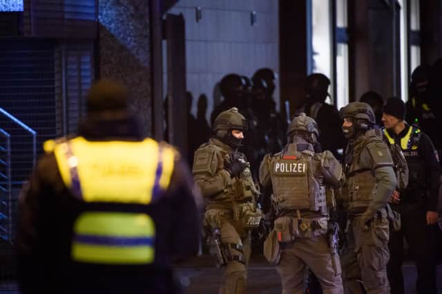 Police officers gather at the scene of a shooting that has left at least six people dead and four wounded in Alsterdorf district of Hamburg (Image: Getty)