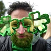 A man wears cloverleaf glasses during a St Patrick's Day parade in Dublin