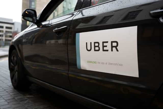 An Uber sticker on the side of a car in Cardiff, Wales. (Image by Matthew Horwood/Getty Images) 