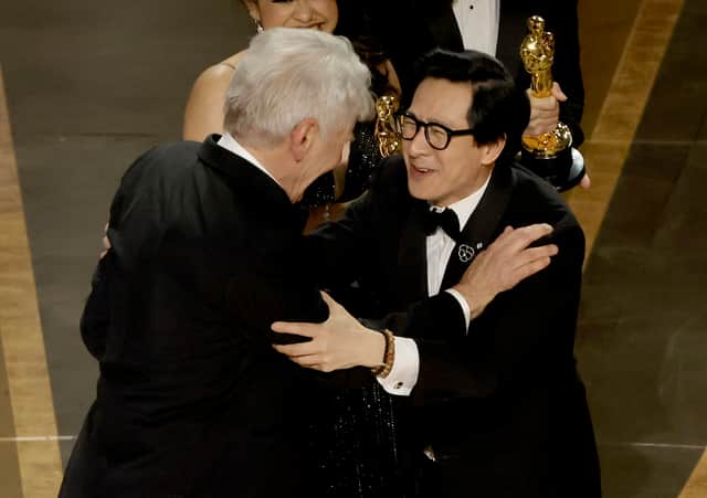Ke Huy Quan (R) accepts the award for Best Picture for “Everything Everywhere All at Once” from Harrison Ford  (Photo: Getty Images)