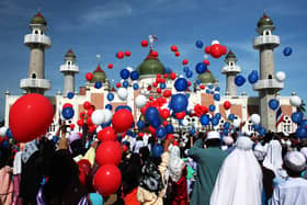Thai Muslims release hundred of balloons after a morning prayer marking the start of the Islamic feast of Eid al-fitr outside Pattani mosque on October 13, 2007 in Pattani, Thailand.