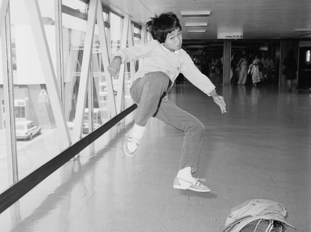 Quan jumping mid-air in martial art position at Heathrow Airport, London in 1984 (Photo: Parker/Daily Express/Hulton Archive/Getty Images)