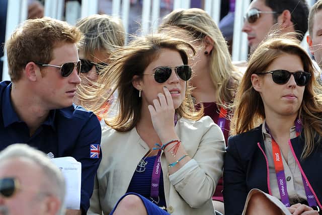 Prince Harry, Princess Eugenie, and Princess Beatrice watch the Eventing Cross Country Equestrian event on Day 3 of the London 2012 Olympic Games at Greenwich Park on July 30, 2012 in London, England. (Photo by Pascal Le Segretain/Getty Images)
