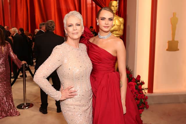 Cara Delevingne posing with Jamie Lee Cutis at the Oscars. Cara looked sensational in a red Elie Saab gown. (Photo by Jesse Grant/Getty Images)