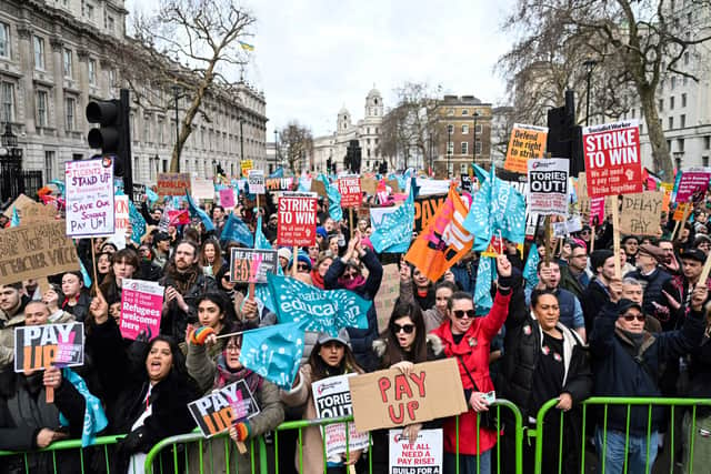 Teachers hold placards and flags while shouting slogans during a protest organised NEU and other affiliated trade unions in London on 1 February 2023 (Photo by JUSTIN TALLIS/AFP via Getty Images) 