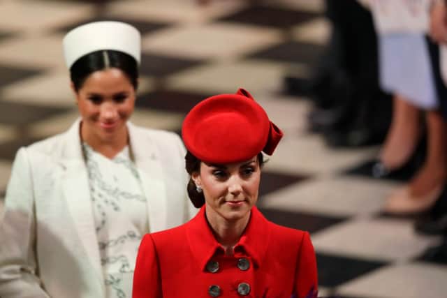 Meghan Markle with Kate Middleton at the Commonwealth Day Service in 2019. She wore a white Erdem coat over a Victoria Beckham dress. Photograph by Getty