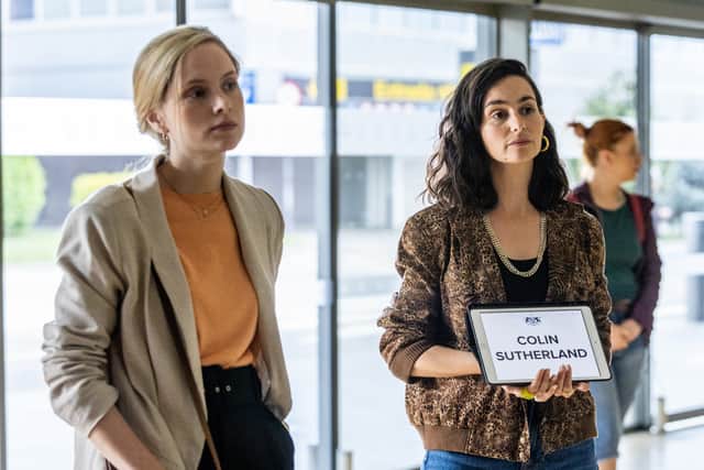Sophie Rundle as Laura Simmonds and Serena Manteghi as Alba Ortiz in The Diplomat, collecting someone from the airport (Credit: UKTV)