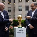 Gianni Infantino and CONCACAF President Victor Montagliani (R) pose with World Cup trophy