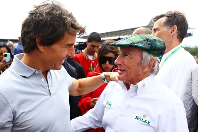 Tom Cruise and Sir Jackie Stewart pose for a photo on the grid prior to the F1 Grand Prix of Great Britain at Silverstone on July 03, 2022 in Northampton, England. (Photo by Mark Thompson/Getty Images)