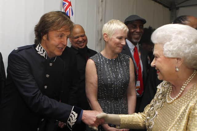 Queen Elizabeth II meets Sir Paul McCartney (L) and Annie Lennox (C) backstage after the Diamond Jubilee, Buckingham Palace Concert June 04, 2012 in London, England. For only the second time in its history the UK celebrates the Diamond Jubilee of a monarch. Her Majesty Queen Elizabeth II celebrates the 60th anniversary of her ascension to the throne. Thousands of well-wishers from around the world have flocked to London to witness the spectacle of the weekend's celebrations.  (Photo by Dave Thompson - WPA Pool/Getty Images)