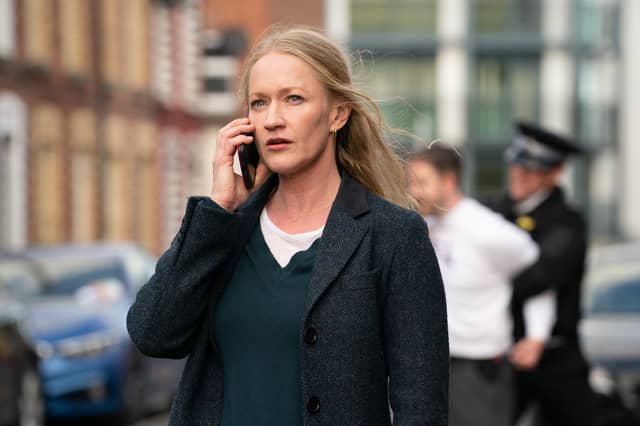 Paula Malcolmson as DCI Collette Cunningham in Redemption, taking a phone call as an arrest is carried out behind her (Credit: ITV)