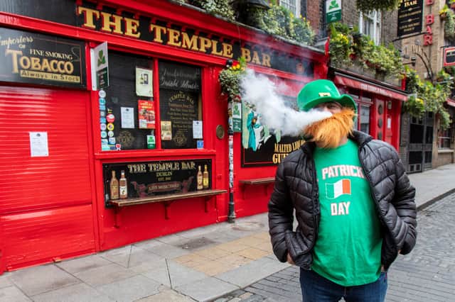 A man vapes outside a pub in the popular Temple bar area of Dublin on St Patrick’s Day. Picture: PAUL FAITH/AFP via Getty Images