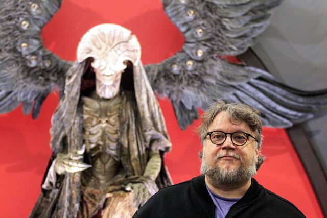 Mexican filmmaker Guillermo del Toro poses with the monster El Angel de la Muerte from the movie “Hellboy” on display at the “Guillermo del Toro, At home with my monsters” exhibition in Guadalajara, State of Jalisco, Mexico, on 29 May 2019. (Photo by Ulises Ruiz / AFP) 