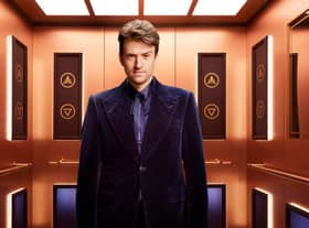 Rise and Fall host Greg James, pictured in the gold elevator (Credit: Channel 4)