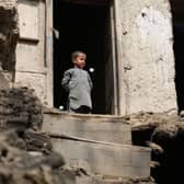 A boy looks out from his damaged home in Miya village, in the Laghman Province on after ab  overnight earthquake that has killed at least 13 people (Photo by SHAFIULLAH KAKAR/AFP via Getty Images)