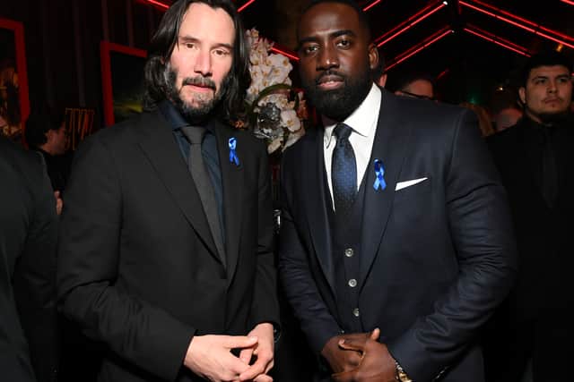 Keanu Reeves and Shamier Anderson wear blue ribbons in memory of Lance Reddick. Picture: Jon Kopaloff/Getty Images for Lionsgate