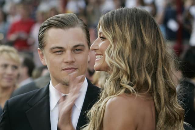 HOLLYWOOD, United States:  CAPTION CORRECTION OBJECT NAME Actor Leonardo DiCaprio, nominated for Best Actor for his role in "The Aviator," arrives with girlfriend Brazilian model Gisele Bundchen for the 77th Academy Awards 27 February, 2005, at the Kodak Theater in Hollywood, California. AFP PHOTO/JEFF HAYNES  (Photo credit should read JEFF HAYNES/AFP via Getty Images)