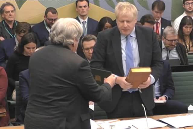 The Clerk to the Committee (left) administers the oath to former prime minister Boris Johnson ahead of his evidence to the Privileges Committee at the House of Commons, London. Picture date: Wednesday March 22, 2023. Credit: PA