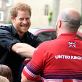 Harry (L) greets members of the team who will represent the United Kingdom at the Invictus games at the Tower of London in central London on May 30, 2017.  / AFP PHOTO / POOL / Jeremy Selwyn        (Photo credit should read JEREMY SELWYN/AFP via Getty Images)