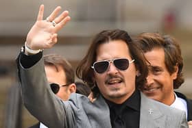 US actor Johnny Depp gestures as he leaves the Hight Court after the final day of his libel trial against News Group Newspapers (NGN), in London, on July 28, 2020. (Photo by DANIEL LEAL/AFP via Getty Images)
