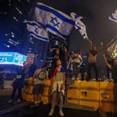 Israeli protesters wave national flags on a barricade as they block a road during a rally against the government’s controversial judicial overhaul bill in Tel Aviv. Picture: AHMAD GHARABLI/AFP via Getty Images