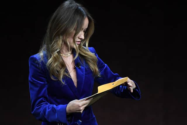 US director and actress Olivia Wilde holds an envelope reading "personal and confidential" as she speaks onstage during the Warner Bros. Pictures "The Big Picture" presentation during CinemaCon 2022 at Caesars Palace in Las Vegas, Nevada on April 26, 2022. - When Olivia Wilde was handed a mysterious envelope on stage midway through her presentation before a packed Las Vegas audience, many assumed it was the set-up for an elaborate joke.Instead, she was getting served legal papers from her ex-partner Jason Sudeikis."This is for me, right?" asked Wilde, interrupted while introducing footage from her upcoming thriller "Don't Worry Darling" during Warner Bros' presentation at CinemaCon, the annual movie theater industry gathering. (Photo by VALERIE MACON / AFP) (Photo by VALERIE MACON/AFP via Getty Images)