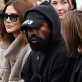 US rapper Kanye West (C), attends the Givenchy Spring-Summer 2023 fashion show during the Paris Womenswear Fashion Week, in Paris, on October 2, 2022. (Photo by JULIEN DE ROSA / AFP) (Photo by JULIEN DE ROSA/AFP via Getty Images)