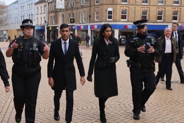 Britain’s Prime Minister Rishi Sunak and Britain’s Home Secretary Suella Braverman walk with police Sergeant Sophie Chesters and police Sergeant Matt Collins during a visit to Chelmsford. Credit: JACK HILL/POOL/AFP via Getty Images