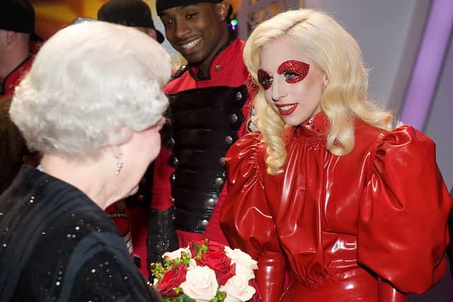 Lady Gaga meeting the late Queen in red latex in 2009.  Photo by Leon Neal/ WPA Pool /Getty Images)