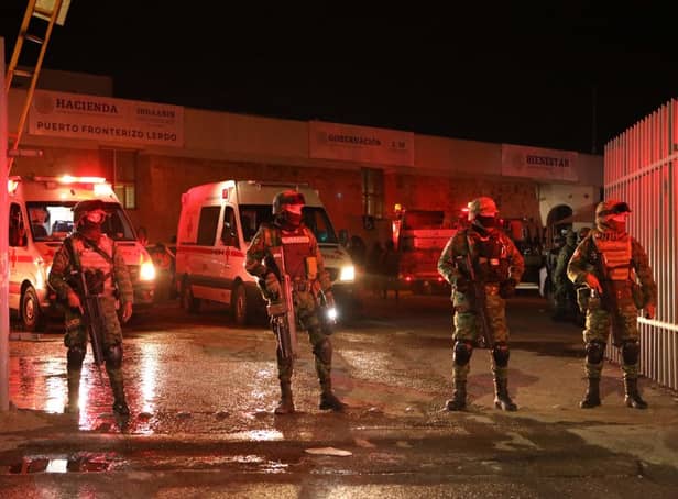 Mexican soldiers stand outside an immigration station in Ciudad Juarez, where at least 39 people were killed and dozens injured in a fire (Photo by HERIKA MARTINEZ/AFP via Getty Images)