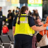 A member of Border Force staff assists an Afghan refugee on her arrival at Heathrow Airport, London, following an evacuation flight from Afghanistan on August 26, 2021. Credit: Getty Images