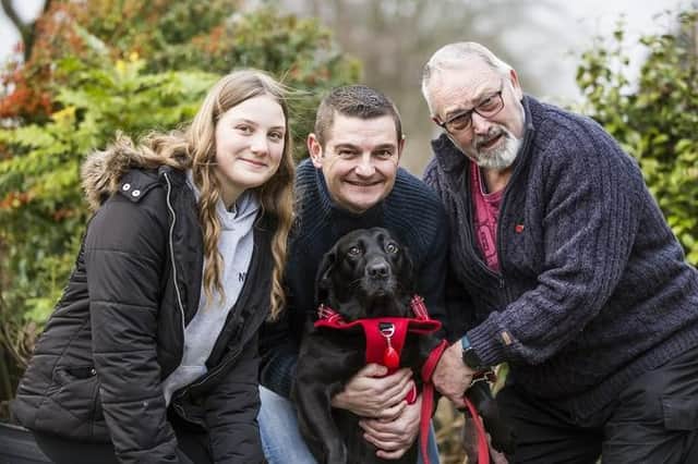 Bella the dog reunited with owner Allan Hough, right, joined by Allan's son, Lee, centre, and granddaughter Isabelle. Photo: Jim Fitton