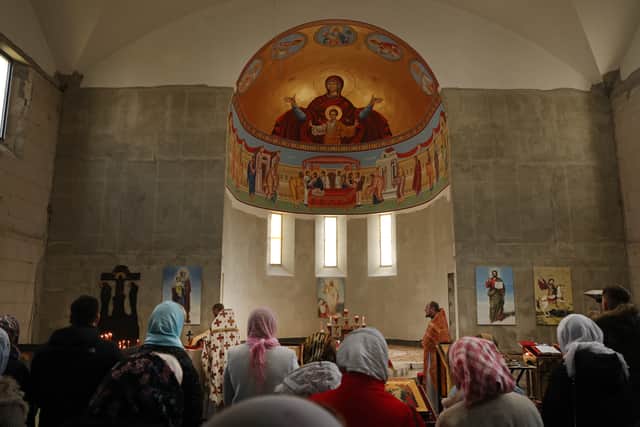 People, among them local Russians and recently arrived Ukrainian refugees, celebrate Orthodox Easter Sunday mass at the Russian Orthodox St. George Monastery, on April 24, 2022 in Goetschendorf, Germany. 
