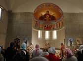 People, among them local Russians and recently arrived Ukrainian refugees, celebrate Orthodox Easter Sunday mass at the Russian Orthodox St. George Monastery, on April 24, 2022 in Goetschendorf, Germany. 