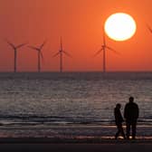 The sun sets behind the wind turbines of Burbo Bank Offshore Wind Farm in the Irish Sea (Photo: Christopher Furlong/Getty Images)