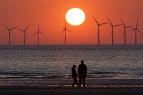 The sun sets behind the wind turbines of Burbo Bank Offshore Wind Farm in the Irish Sea (Photo: Christopher Furlong/Getty Images)