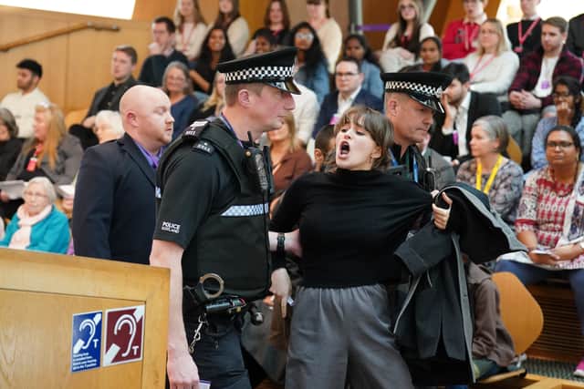 Protesters were removed by police from the public gallery after yelling during FMQs. (Credit: PA)