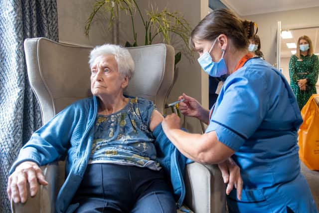 Registered Nurse Laura Hastings administers a covid booster to Agnes Taylor, 93, at Victoria Manor Care home on September 5, 2022 (Photo by Lesley Martin - Pool/Getty images)