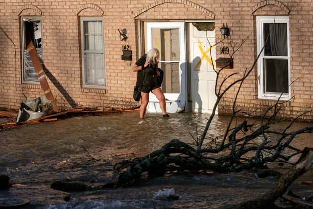 A woman evacuates from her home after a large tornado damaged hundreds of homes and buildings on March 31, 2023 in Little Rock, Arkansas. (Photo by Benjamin Krain/Getty Images)