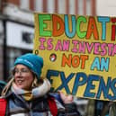 Teachers and members of the National Education Union (NEU) hold placards during a demonstration called by the NEU trade unions in the streets of Reading, on February 1, 2023 during a national strike day.  (Photo by Adrian DENNIS / AFP) (Photo by ADRIAN DENNIS/AFP via Getty Images)