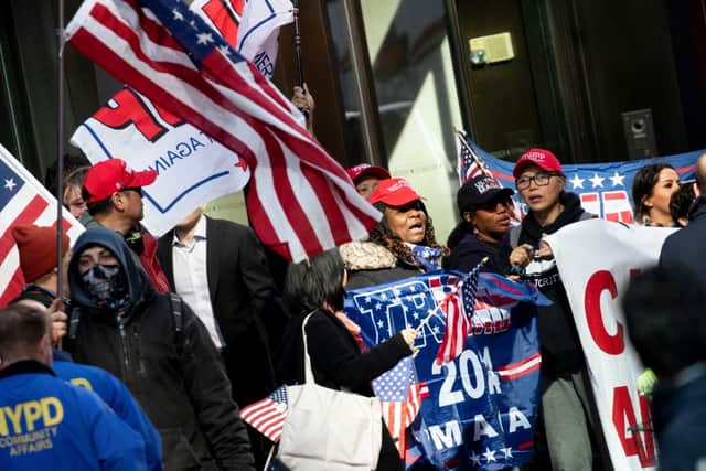 Supporters of Donald Trump gather at Trump Tower in New York on April 3, 2023. Credit: Photo by STEFANI REYNOLDS/AFP via Getty Images.